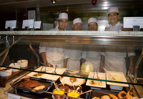 Chefs at the counter where made to order steaks and other custom meals are