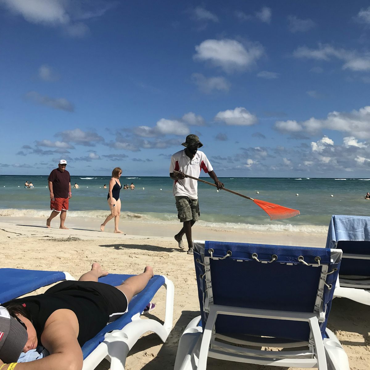 Jamaica mon- raking the beach!