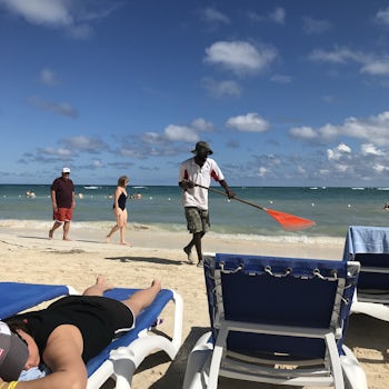 Jamaica mon- raking the beach!