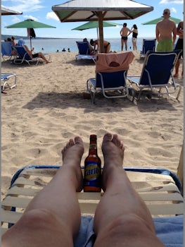 Ice cold Caribe beer, a must try on Cockleshell beach. The water here is re
