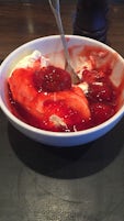 dessert of cream and strawberries