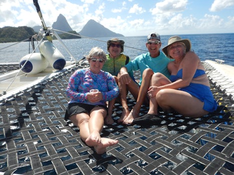 enjoying the sun the the front of the catamaran on our excursion to see the