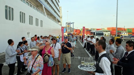 Viking Sky crew welcoming passengers back onto the ship with champagne