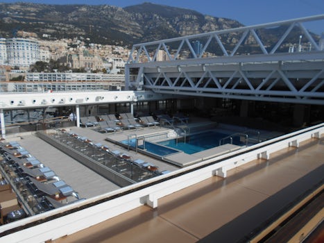 Retractable pool cover open to the sunlight of Monaco.