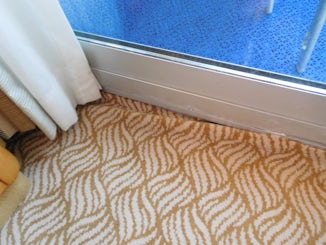 Carpet not finished off correctly.  Curls up at the sliding door.