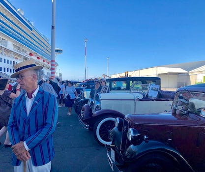 Antique cars and owners in Napier wait on dock to welcome you back to see t
