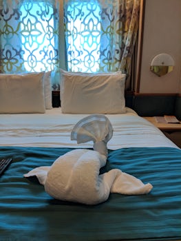 Comfortable bed with towel animal.