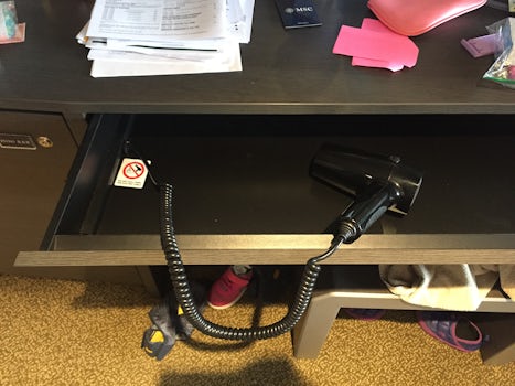 Oddly, the hair dryer is permanently attached to the desk with no signs poi