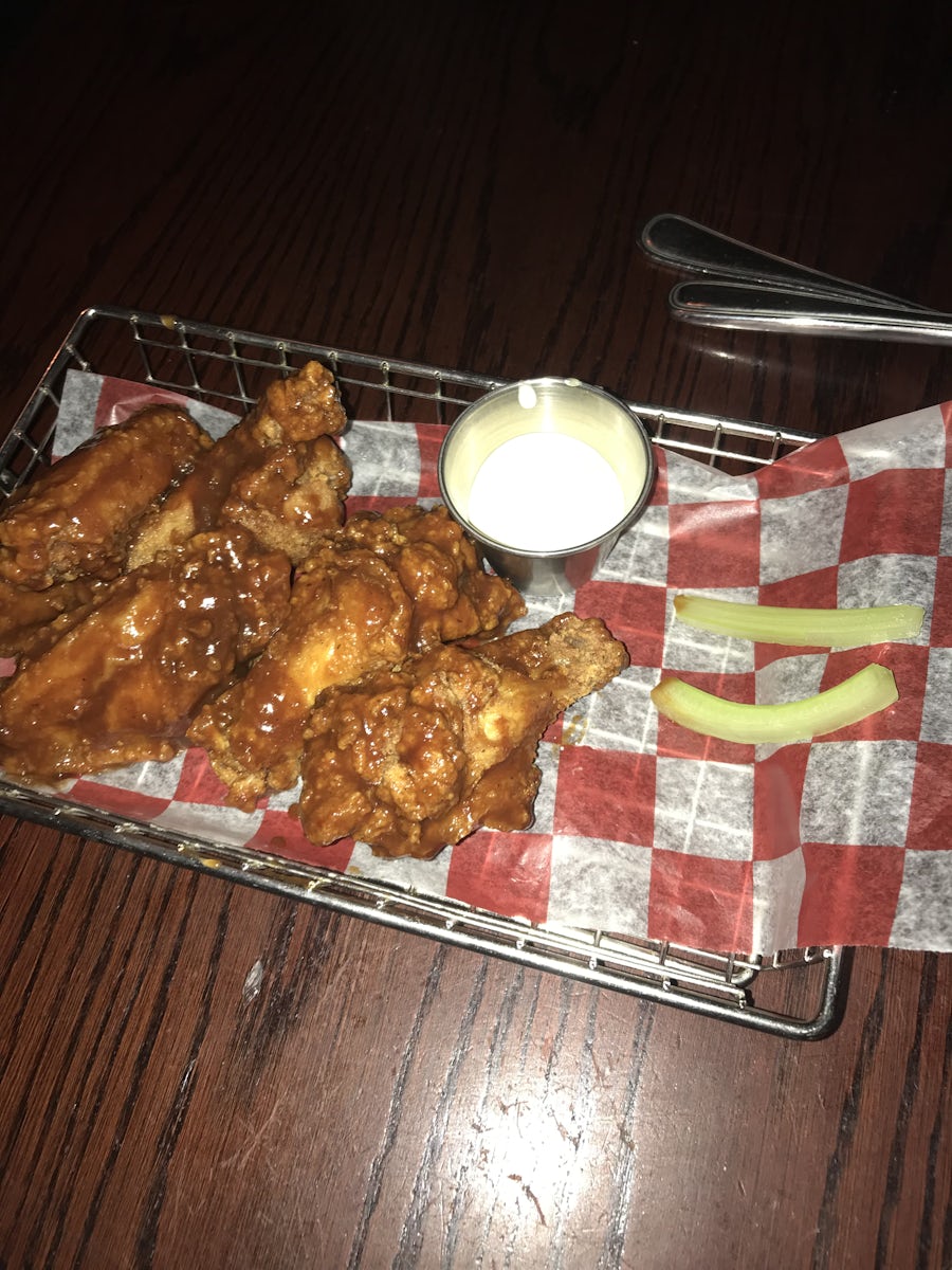 Wings at O’ Shannan’s were actually very good. However, the service was awful. Being my first cruise I asked if I could get them to go and the host puts his hand up and says “No!”. I then tell my server my order and she replies “ok” without making eye contact and walking away. Then priced exes to bring a glass of water after the food was served.