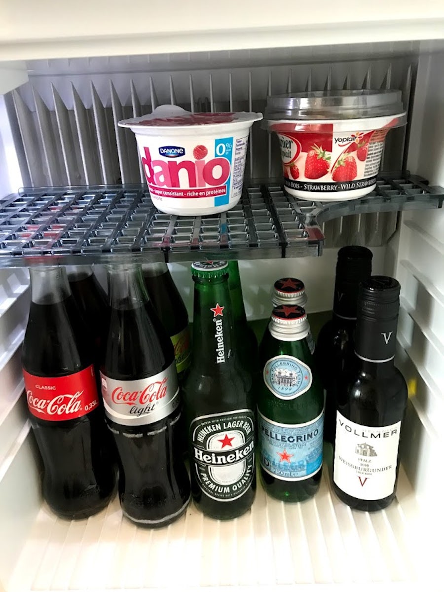 Mini fridge stocked with coke, beer and water