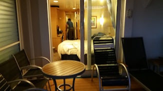 Photo taken at night from the railing looking into the cabin, bed on right