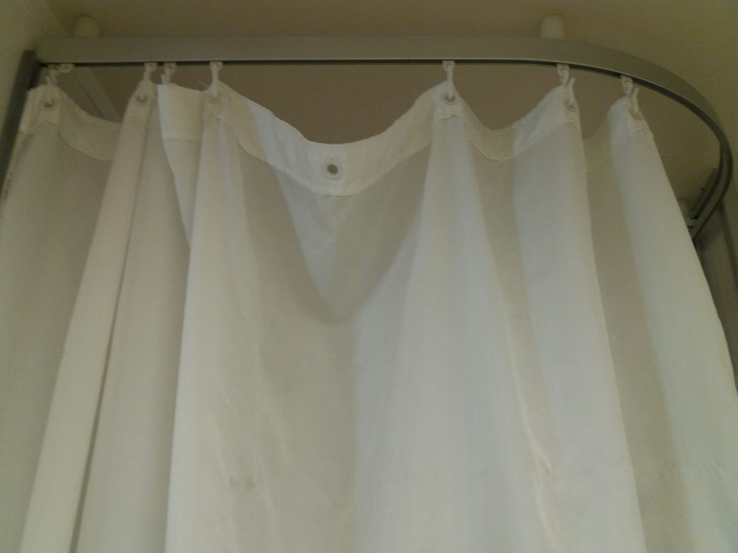 Shower curtain. Who uses curtains in the shower in the 21st century? Much less in this shape....