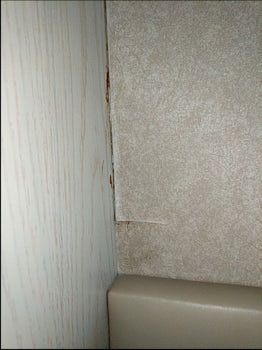 Peeling wallpaper in cabin.