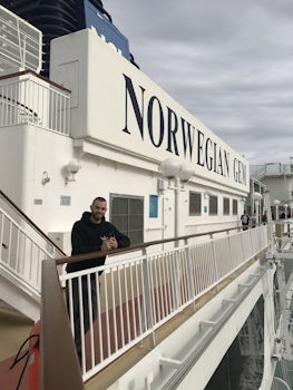 My friend on deck 12 in front of the Norwegian Gem sign