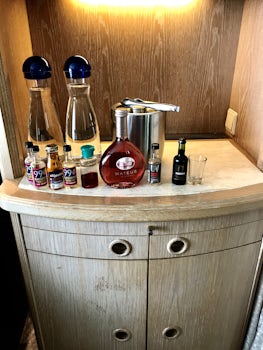 Bar with a variety of drinking glasses & a mini-fridge