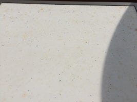 Dirty soot particles on balcony table found every morning.