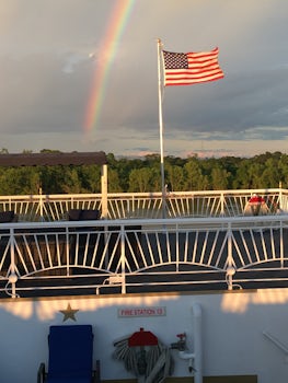 A rainbow appears alongside the American flag on Memorial Day.