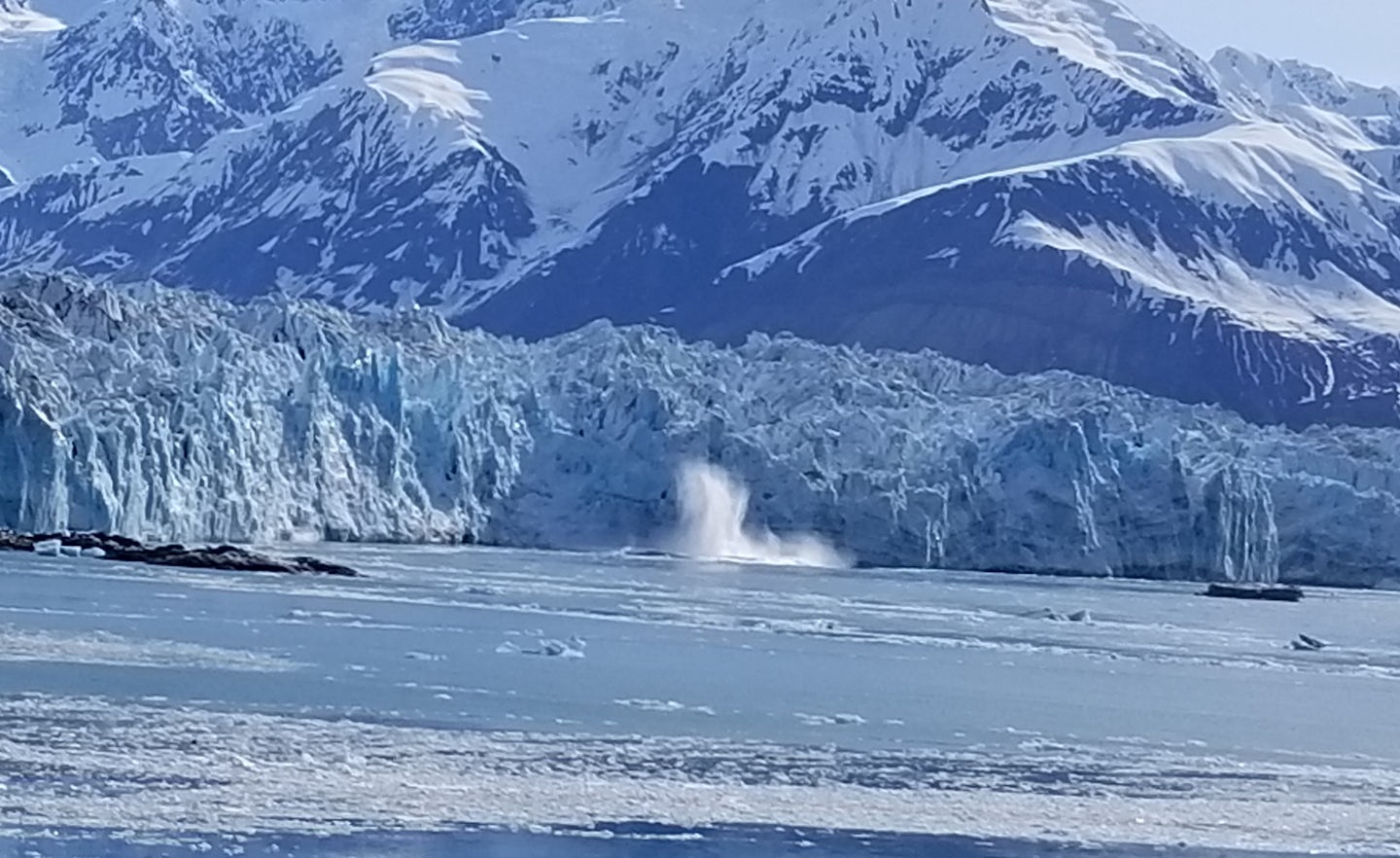 Ice actively falling from the Hubbard Glacier viewed from the helipad of th