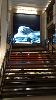 Munch's paintings projected at top of staircase.