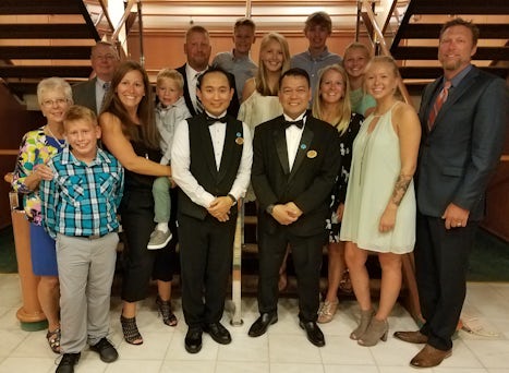 Our family with our waiter and assistant waiter on formal night.
