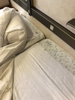 Old cheap twin mattresses slid together to imitate the King size bed I paid