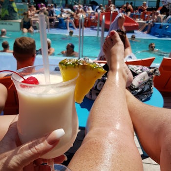 Lounging at the pool with a drink