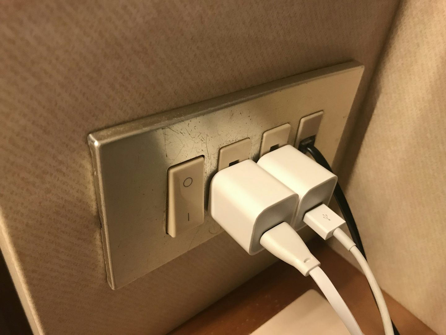 The only accessible (usable) electrical outlet in the room next to the desk
