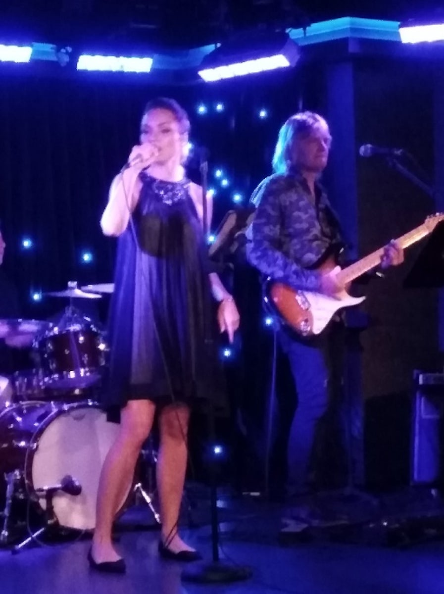 The lovely and talented Valeria Rivna onstage in The Fat Cats Lounge accompanied by the electric guitar of Cornell Bratila of the ships band Let's Groove entertaining passengers with their smooth sounds.