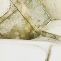 Urine stained marble around toilet.