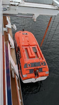 Tender being lowered at a port. The tender lifeboats were comfortable and t