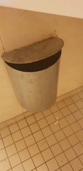 Obsolete Rubbish bin in bathroom, still had rubbish in it,  made of tin and