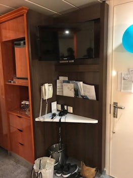 oceanview stateroom - tiny desk under flatscreen TV with mini-bar fridge an