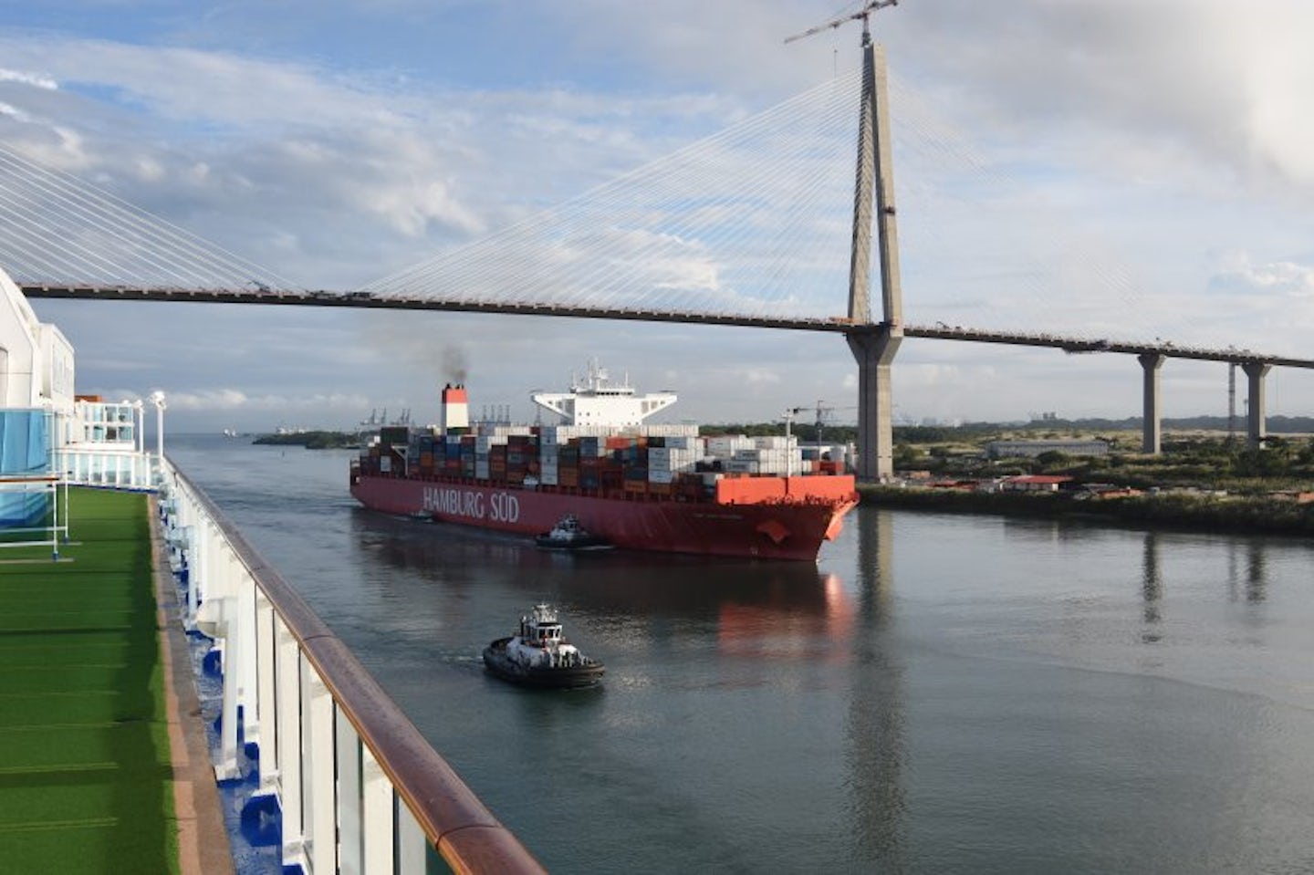 Ocean freighter passes under the bridge and along side of the Island Prince