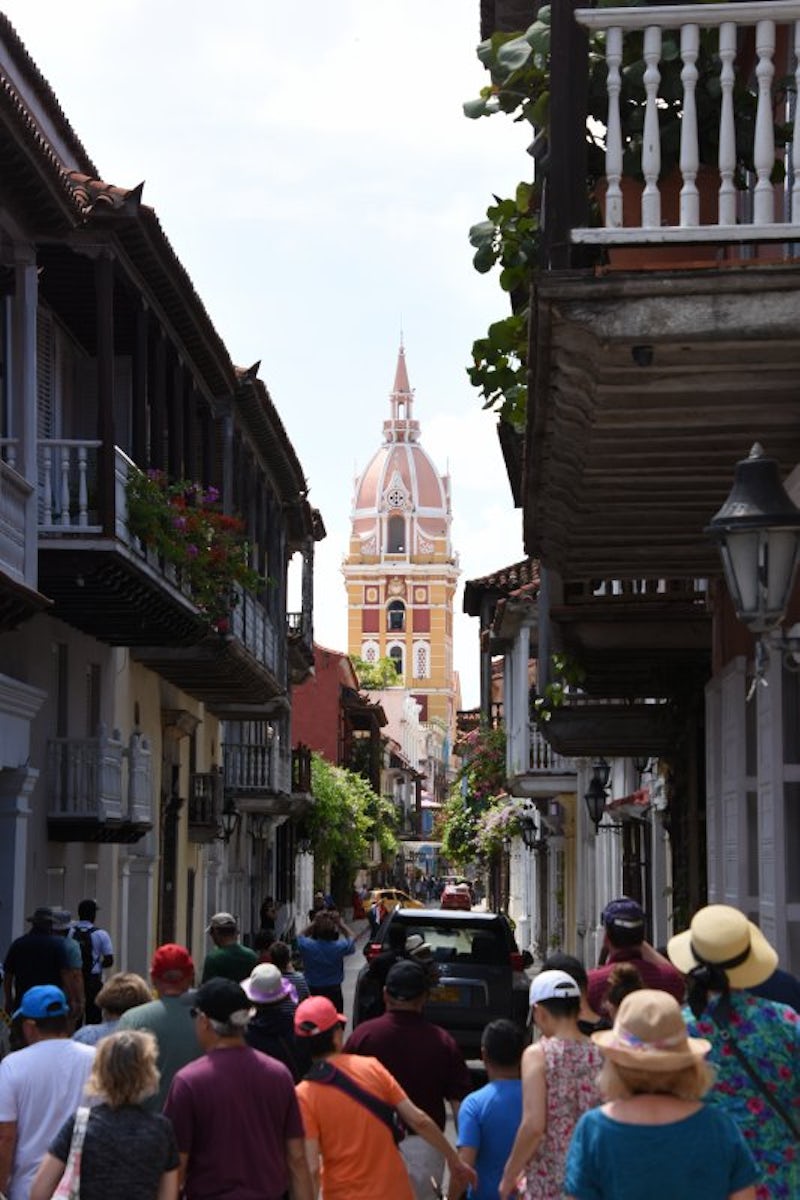 The steeple of the cathedral at Cartagena is visible through tne narrow str