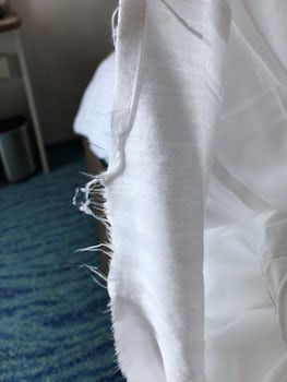 More frayed sheets in a balcony cabin
