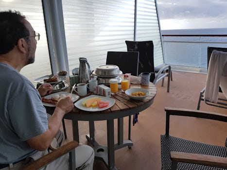 Breakfast on our balcony. Sitting this end, you stay dry, although if it ra