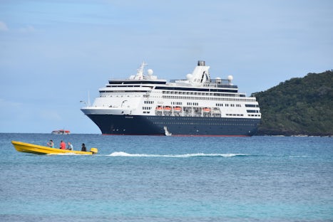 Ship off Dravanui Island and islanders taking some passengers for ride arou
