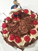 Black forest anniversary cake with fondant superman topper