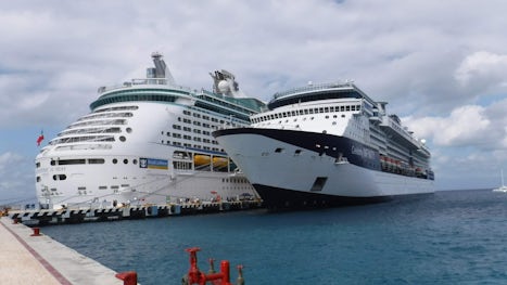 Infinity next to the Adventure of the Seas at port