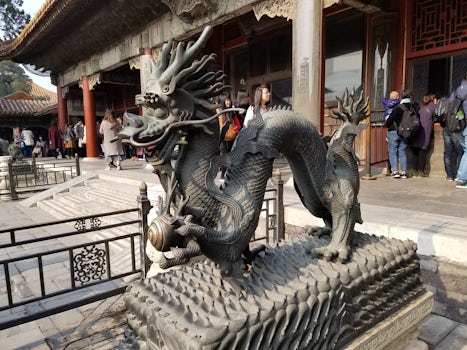 One of the many sculptures and the Forbidden City