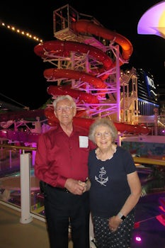 My parents on deck 16 with water slides behind them.