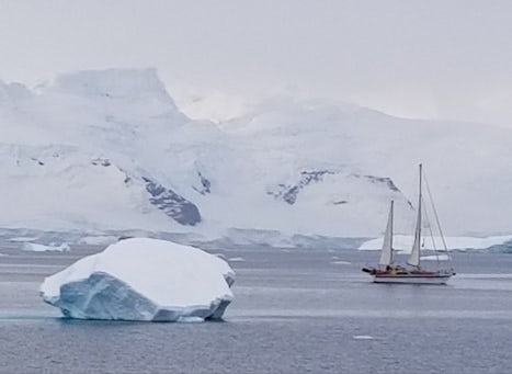 sailboat cruising among the icebergs