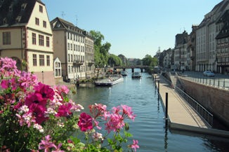 Strolling across a bridge in Strasbourg, which is enclosed on all sides by 