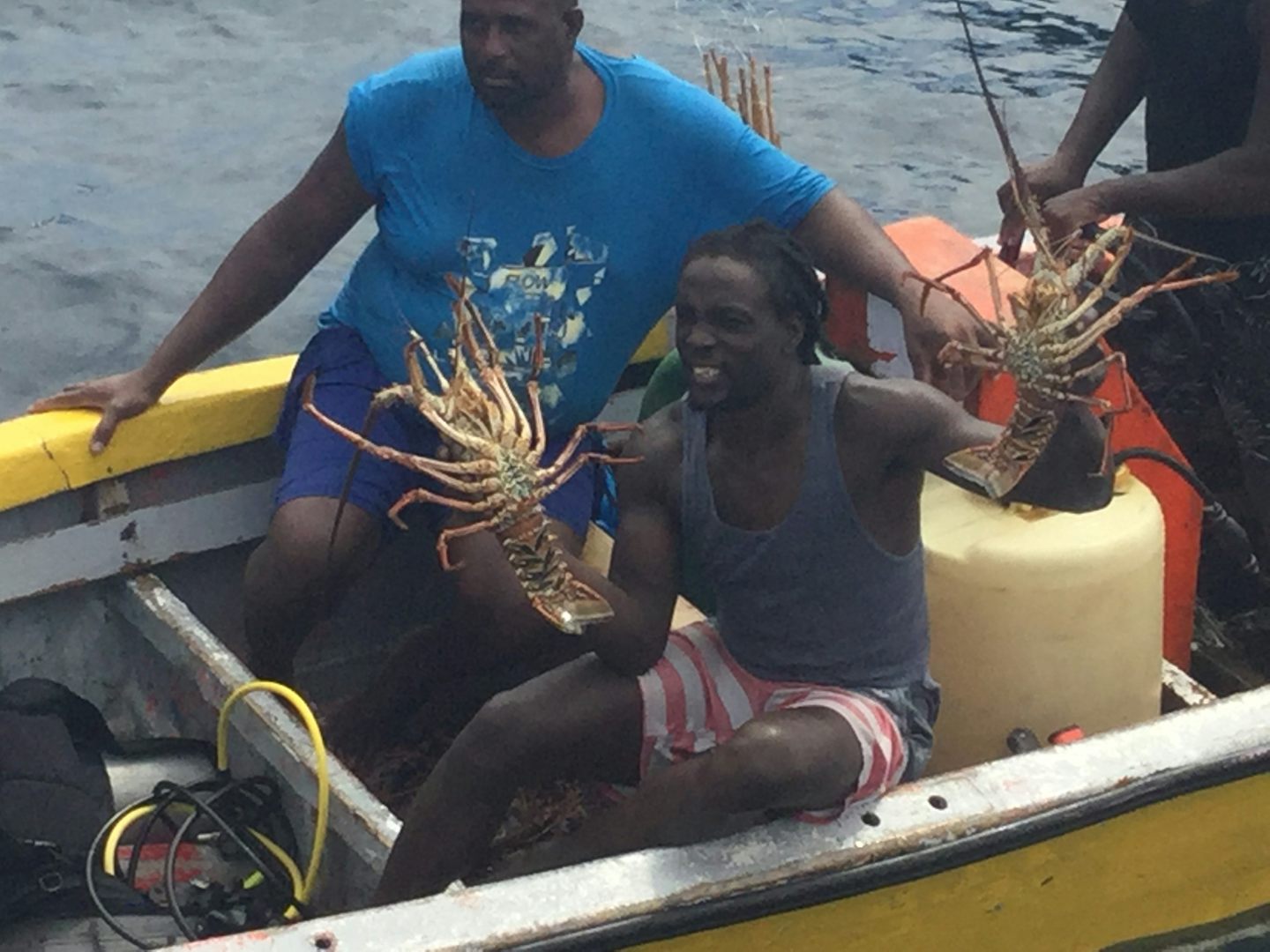 Locals coming beside the ship to offer lobsters