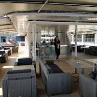 Covered, outdoor lounge and bar area on 4th deck
