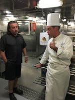 Behind the scenes tour.  My DH quizzing the Chef.  