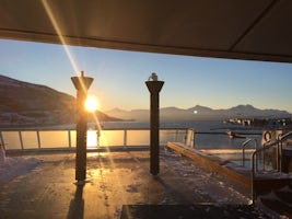 Noon Sun in the port of Tromso, looking aft from the ship.