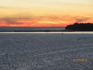 Sunset, leaving port of LA. Point Fermin Park in the back round