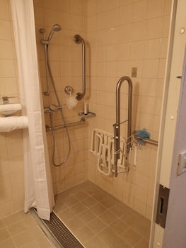 The shower are with the obstructing bar.
