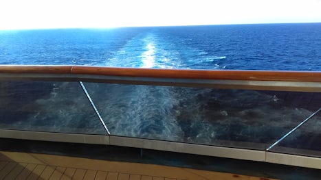 Sitting on the very large Aft Balcony.  Beware, soot was a problem.  Our steward cleaned everyday spraying the deck down.  We always seemed to have water out there, but he was trying to keep the soot down.